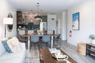 a living room and kitchen with a table and chairs at Revylation by Revelstoke Vacations in Revelstoke