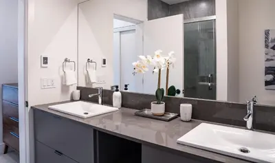 a bathroom with two sinks and a large mirror at Revylation by Revelstoke Vacations in Revelstoke