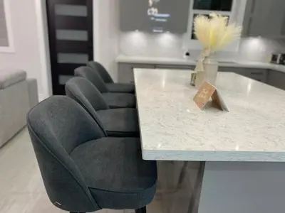 a table with two chairs and a white counter top at Modern and New house near PNE with Big Garden and Free Parking in Vancouver