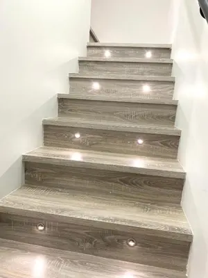 a stairway with wooden steps with lights on it at Modern and New house near PNE with Big Garden and Free Parking in Vancouver