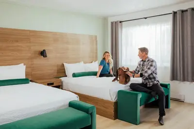 a man and a woman in a hotel room at Ucluelet Wildwood Inn in Ucluelet