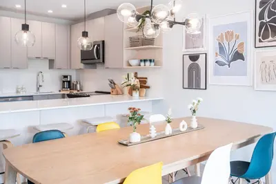 a kitchen and dining room with a wooden table and chairs at Western Star by Revelstoke Vacations in Revelstoke