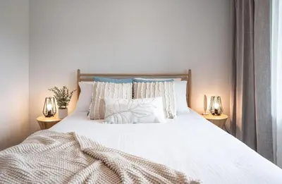 a bedroom with a large white bed with two lamps at Western Star by Revelstoke Vacations in Revelstoke