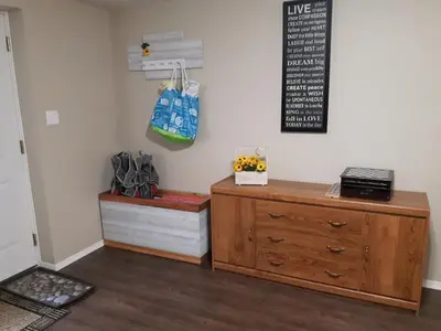 a room with a dresser and a chalkboard on the wall at Comfy KING Bed, Large private Basement Suite, Smart TV in Penticton- city of PEACHES AND BEACHES in Penticton