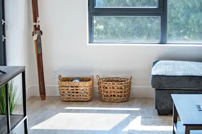 a living room with two baskets and a couch at The Grizzly Basin by Revelstoke Vacations in Revelstoke