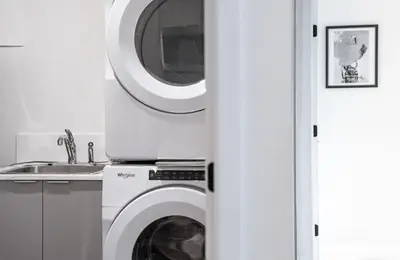 a washing machine in a kitchen next to a sink at The Grizzly Basin by Revelstoke Vacations in Revelstoke