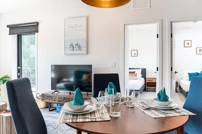 a dining room with a wooden table and blue chairs at Rummy's Adventure Bay by Revelstoke Vacations in Revelstoke