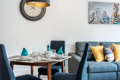 a dining room with a table and a couch at Rummy's Adventure Bay by Revelstoke Vacations in Revelstoke