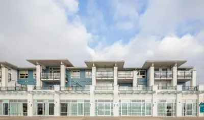 an apartment building with a blue and white facade at Steveston Waterfront Hotel in Richmond