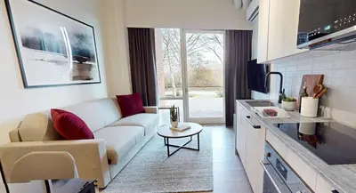a living room with a couch and a table at Steveston Waterfront Hotel in Richmond