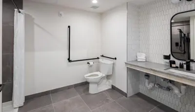 a bathroom with a toilet and a sink at Steveston Waterfront Hotel in Richmond