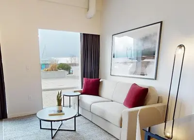 a living room with a couch and a table at Steveston Waterfront Hotel in Richmond
