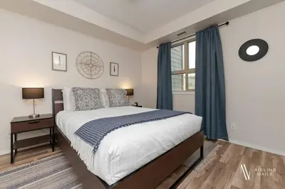 a bedroom with a large bed and a window at Light N Airy, Pool, Hot Tub, Pets, Ground Floor in Invermere