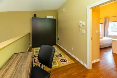 a room with a table and a chair and a bedroom at NN - The Loft - Downtown 1-bed 2-bath in Whitehorse