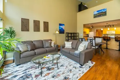 a living room with two couches and a table at NN - The Loft - Downtown 1-bed 2-bath in Whitehorse