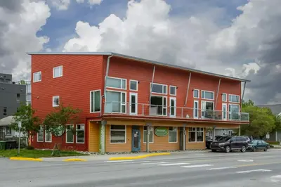a red building on the side of a street at NN - The Loft - Downtown 1-bed 2-bath in Whitehorse