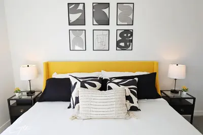 a bedroom with a bed with black and white pillows at Beautiful 3 King Beds,Garage,Airport,Disney+ in Edmonton