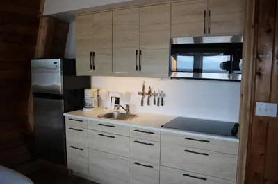 a kitchen with a sink and a refrigerator at Jewel Bay Resort in Sorrento