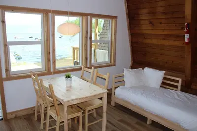a bedroom with a table and a bed and a table and chairs at Jewel Bay Resort in Sorrento