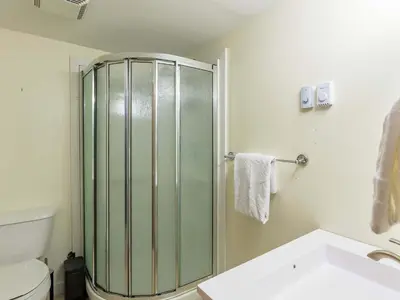a bathroom with a shower and a toilet and a sink at The Alpine I No Service Fee's I Ski-in Ski-Out I in Silver Star