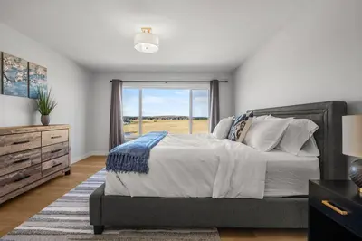 a bedroom with a large bed and a window at Bright & Spacious 3 Beds Luxury Home in SE Calgary in Calgary