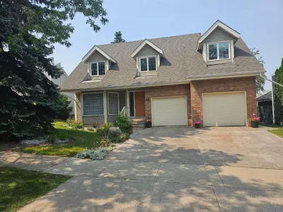 a house with two garage doors on a driveway at Window Hill in St. Albert