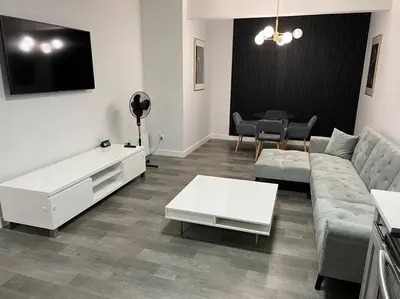 a living room with a couch and a table at Modern Luxury Private Suite in Airdrie