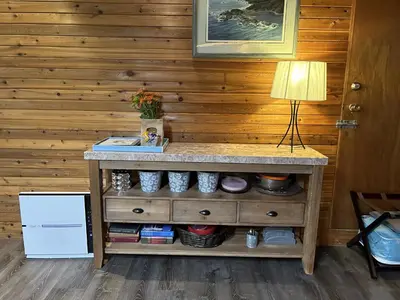 a wooden wall with a table with a lamp on it at Charming Hidden Gem- Ocean View and Marina in Campbell River