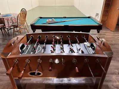 a pool table with a rack of cue sticks at Charming Hidden Gem- Ocean View and Marina in Campbell River