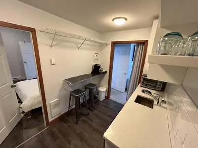 a kitchen with a counter and a sink in a room at Charming Hidden Gem- Ocean View and Marina in Campbell River