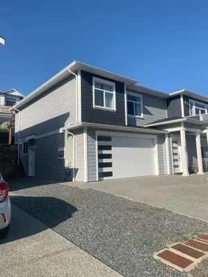a house with a car parked in front of it at Entire 2BR Guest House in Quiet Area in Nanaimo