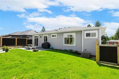 a house with a yard with a fence at Entire 2BR Guest House in Quiet Area in Nanaimo