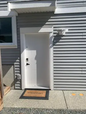 a white garage door on the side of a house at Entire 2BR Guest House in Quiet Area in Nanaimo
