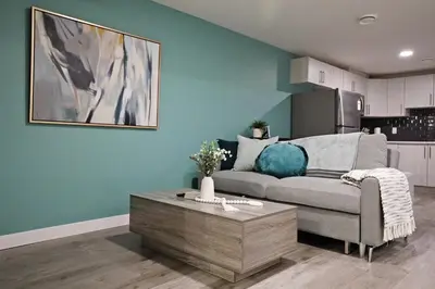 a living room with a couch and a coffee table at Beautiful Suite King Bed,Long Stays,Disney,Airport in Edmonton