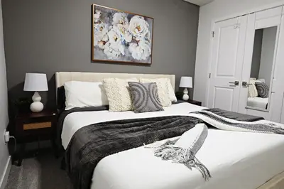 a bedroom with two beds and a painting on the wall at Beautiful Suite King Bed,Long Stays,Disney,Airport in Edmonton