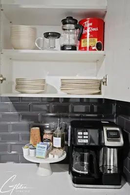 a kitchen with a coffee maker and plates on a shelf at Beautiful Suite King Bed,Long Stays,Disney,Airport in Edmonton