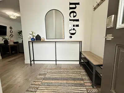 a hallway with a mirror and a dressing room at Beautiful Home With 4 King Beds,Airport,Disney+ in Edmonton