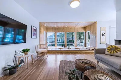 a living room with a couch and a table at Three-Tree Villa-Central Location in Vancouver