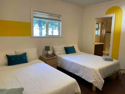 a bedroom with two beds and a window at Westside Pool Home-8 min to Downtown, Yard Parking in Vancouver
