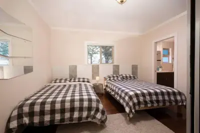 a bedroom with two beds and a window at Westside Pool Home-8 min to Downtown, Yard Parking in Vancouver