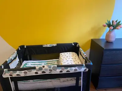 a baby crib with a pillow in a room at Westside Pool Home-8 min to Downtown, Yard Parking in Vancouver