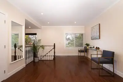 a living room with a staircase and a table and chairs at Westside Pool Home-8 min to Downtown, Yard Parking in Vancouver