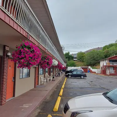 a building with flowers hanging on the side of it at Canadas Best Value Inn & Suites-Vernon in Vernon