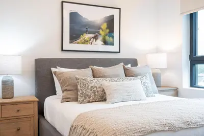 a bedroom with a bed with a picture on the wall at Farwell's Spike by Revelstoke Vacations in Revelstoke