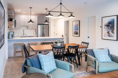 a kitchen and dining room with a table and chairs at Farwell's Spike by Revelstoke Vacations in Revelstoke