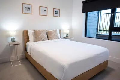 a bedroom with a large white bed and a window at Revy Mountain Retreat in Revelstoke