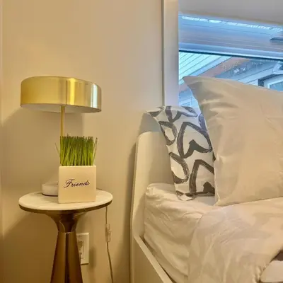 a lamp on a side table next to a bed at Immersed in the scenery of Canmore in Canmore