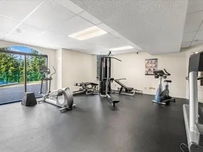 a gym with treadmills and cardio equipment in a room at Ski In/Out, Steam Shower, Pool, Hot Tub, Sauna in Whistler