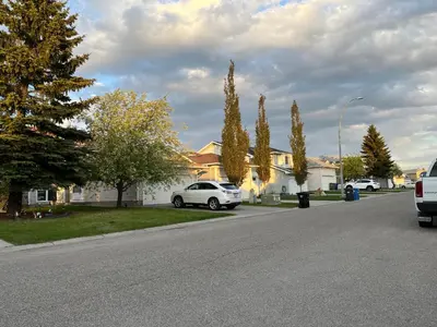 a white car parked on the side of a street at citadel cozy quilt private bedroom in Calgary