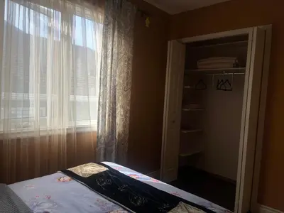 a bedroom with a bed and a window with curtains at citadel cozy quilt private bedroom in Calgary